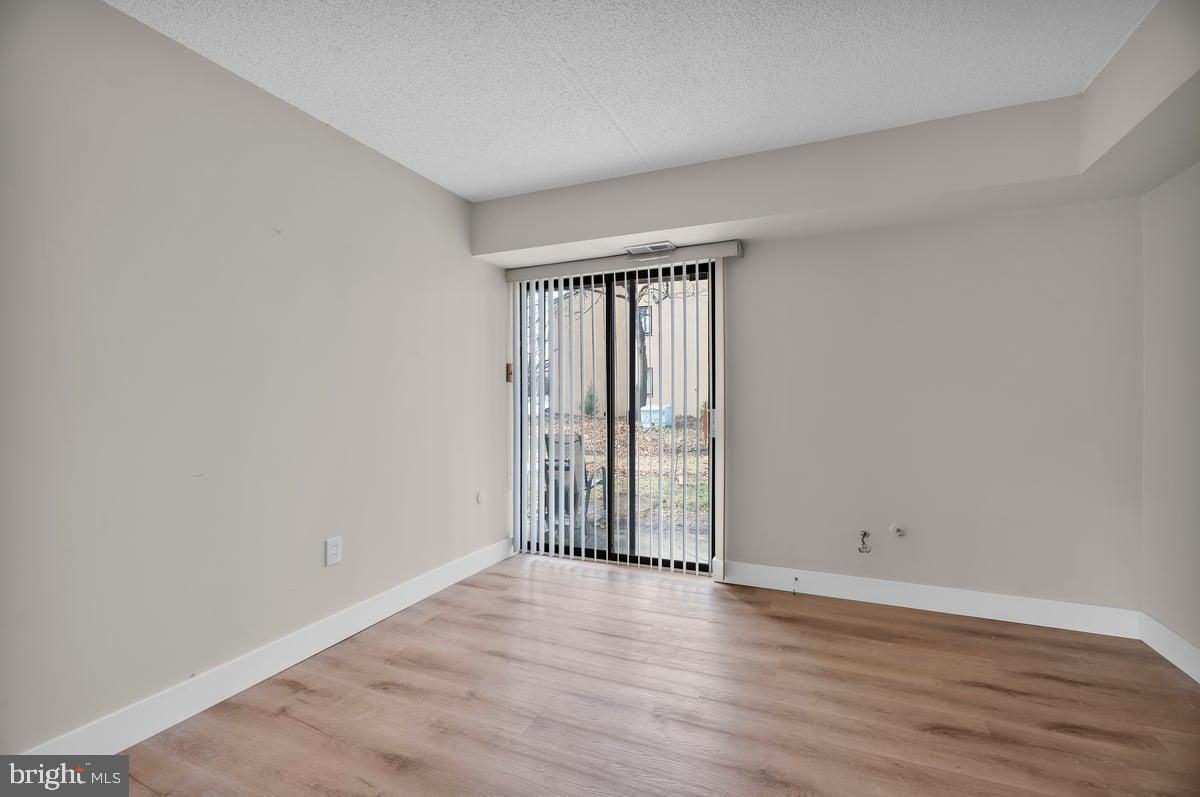223 James Marlton, NJ 08053 - Photo 10 of 28 a view of an empty room with wooden floor and a window