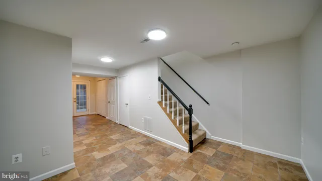 an entryway in a hall with wooden floor