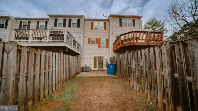 a view of a house with wooden fence