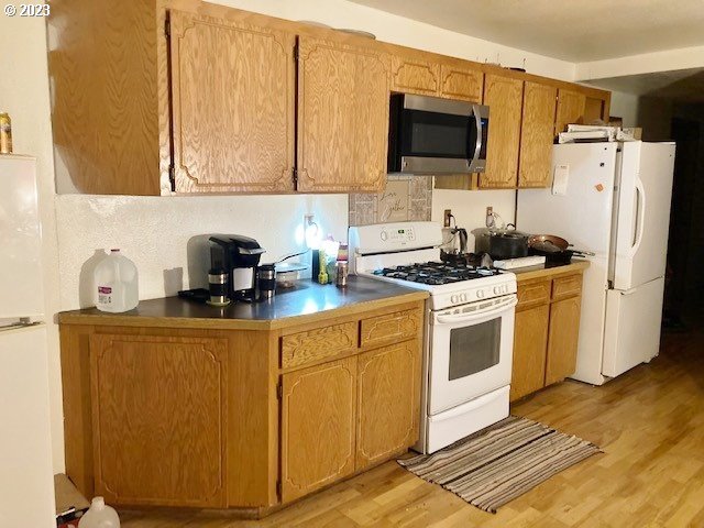 3201 Northeast Riverside Avenue Pendleton, OR 97801 - Photo 13 of 48 a kitchen with stainless steel appliances a stove a microwave a refrigerator a sink and cabinets