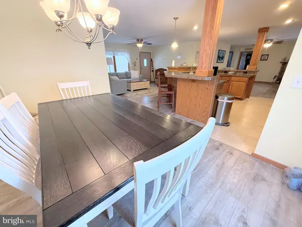 a kitchen with a table chairs and a chandelier