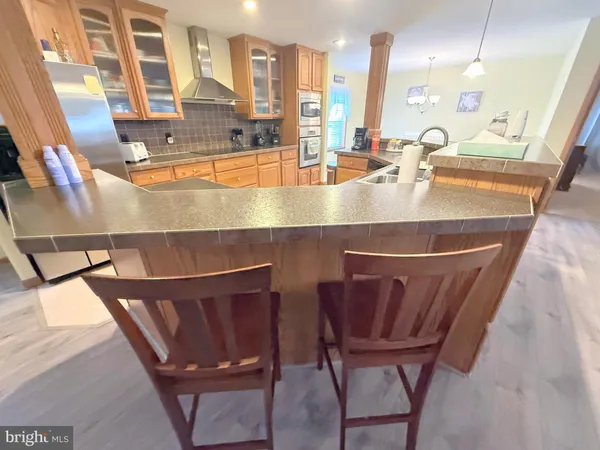 a room with table chairs and wooden floor