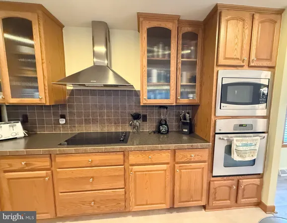 a kitchen with granite countertop a sink and a stove