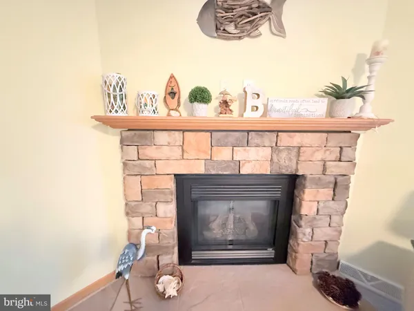 a fireplace with a vase on top of it