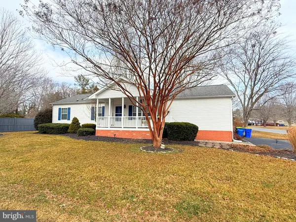 a view of a house with snow on the side of the road