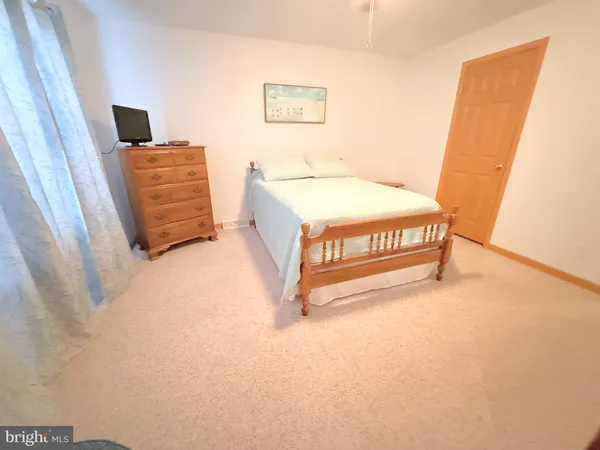 a spacious bedroom with a bed and a couch