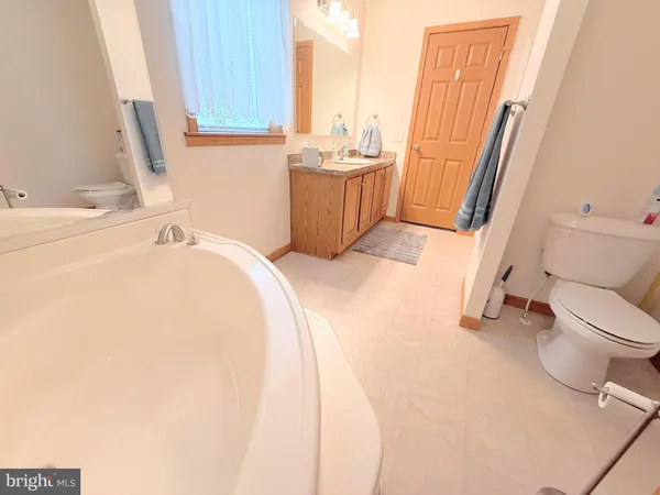 a bathroom with a sink a toilet and a tub