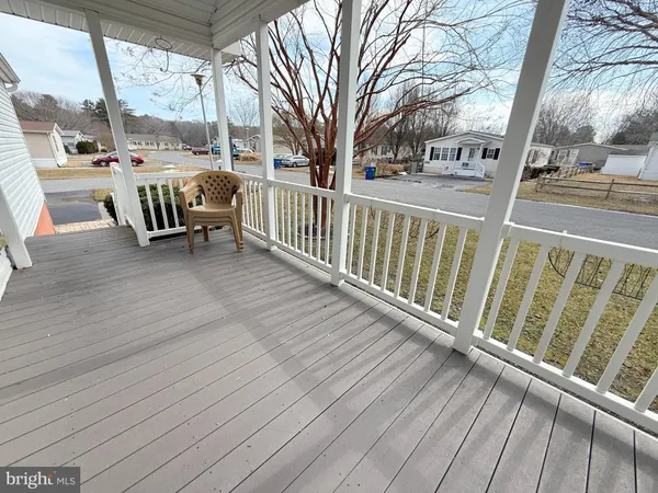 a view of a balcony with wooden floor and fence