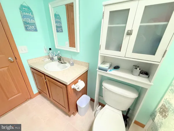 a bathroom with a sink vanity mirror and toilet