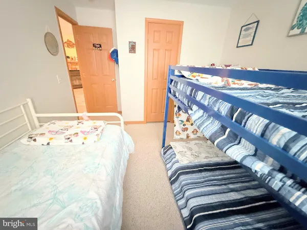 a view of walk in closet with rug and wooden floor