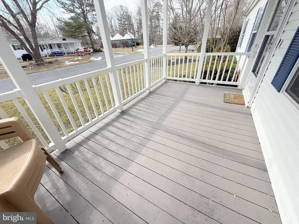 a view of a balcony with wooden floor