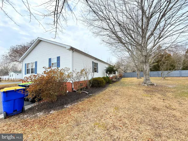 a view of a house with a yard covered in snow