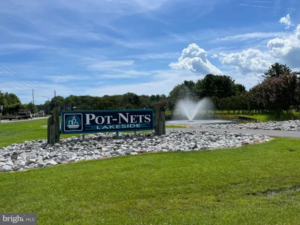a view of a wooden fence and a big yard