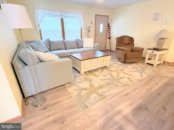 a living room with furniture and a lamp