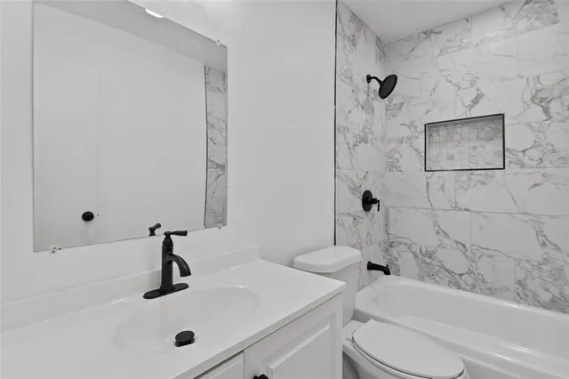 a bathroom with a sink a toilet and a bathtub