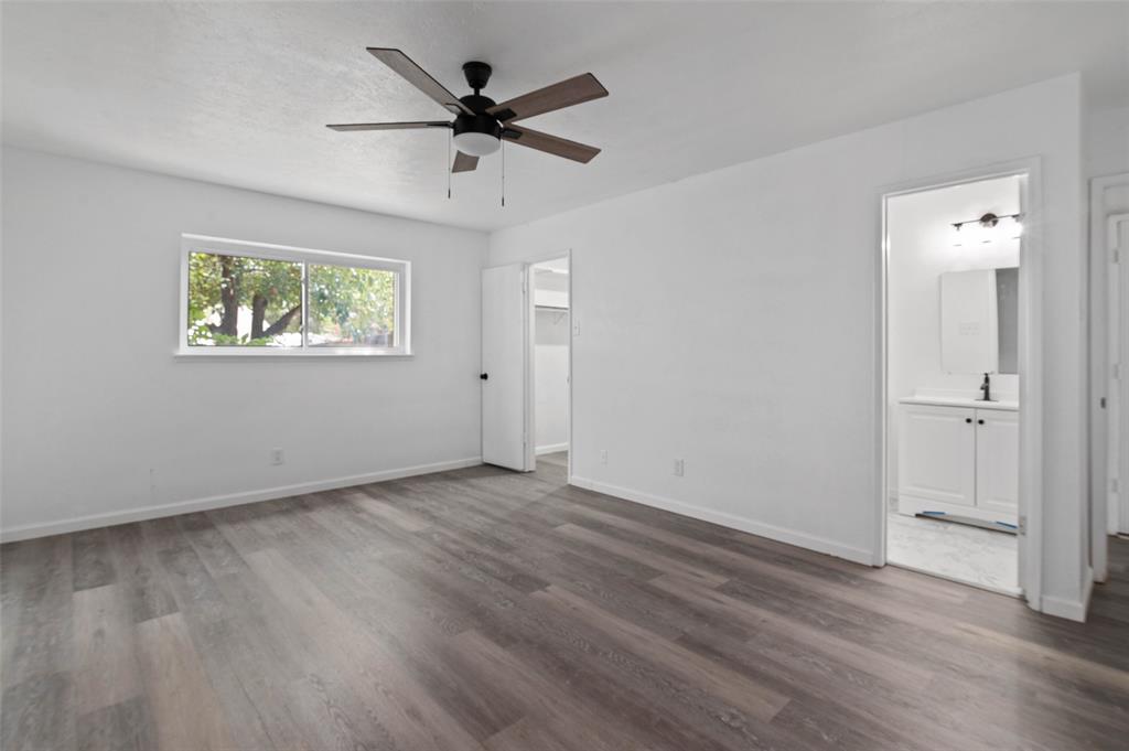 2068 East Peters Colony Road Carrollton, TX 75007 - Photo 15 of 24 an empty room with wooden floor and windows