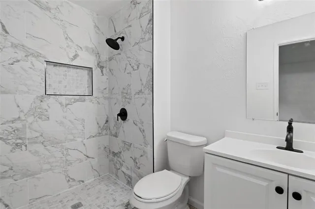 a bathroom with a toilet sink and shower