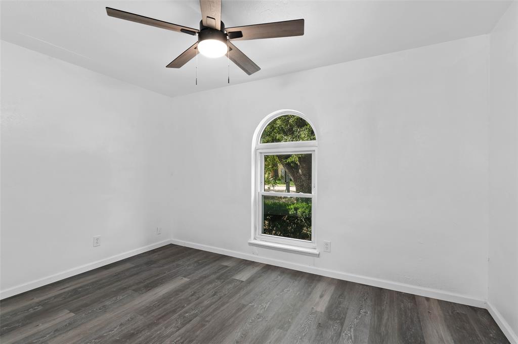 2068 East Peters Colony Road Carrollton, TX 75007 - Photo 9 of 24 an empty room with wooden floor ceiling fan and window