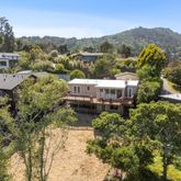 a view of a house with a mountain and a forest