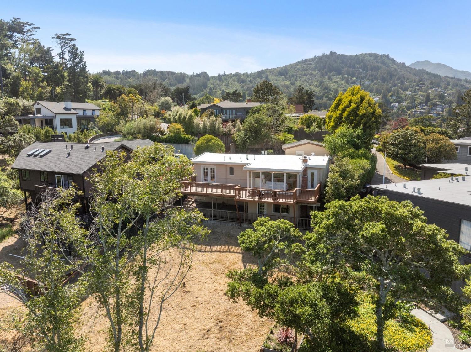 a view of a house with a mountain and a forest