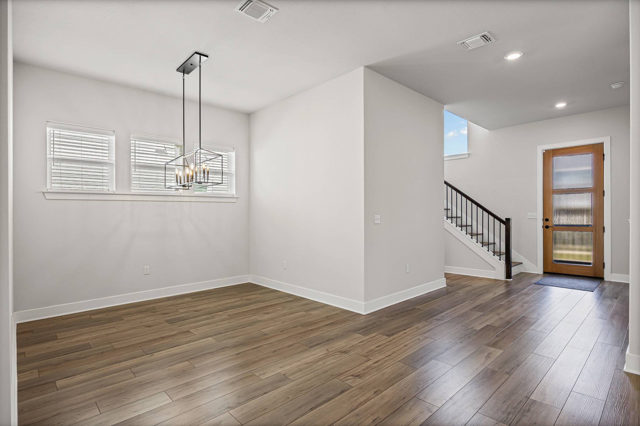 5806 Rangeland Road Austin, TX 78747 - Photo 12 of 34 Enter into a vast, sun-filled living space, complete with durable flooring and modern light fixtures.