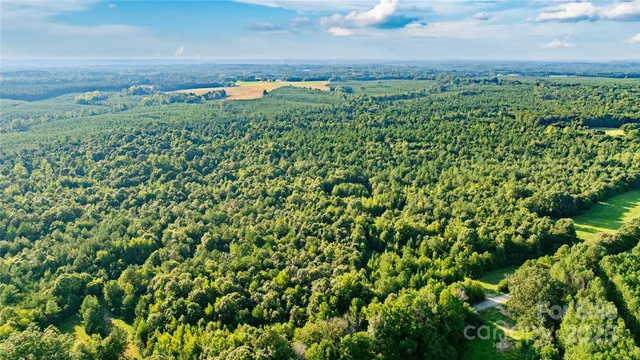 an aerial view of a houses with a yard