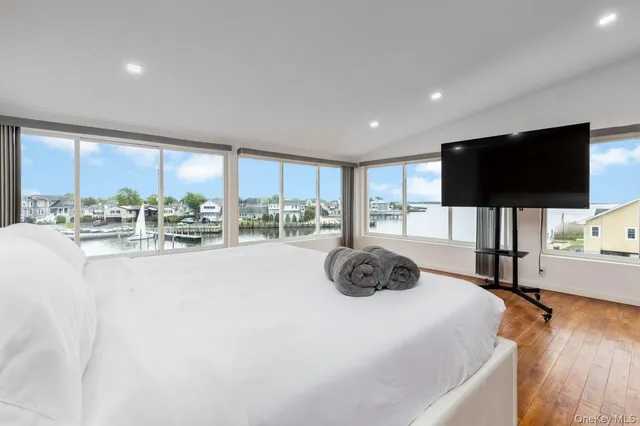 a living room with a flat screen tv and a large window