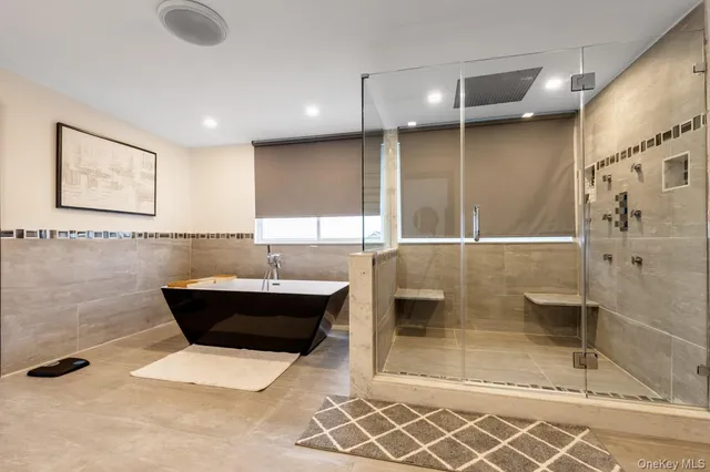 a large bedroom with a large bed and a large window