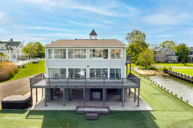 an aerial view of a house with a garden and lake view
