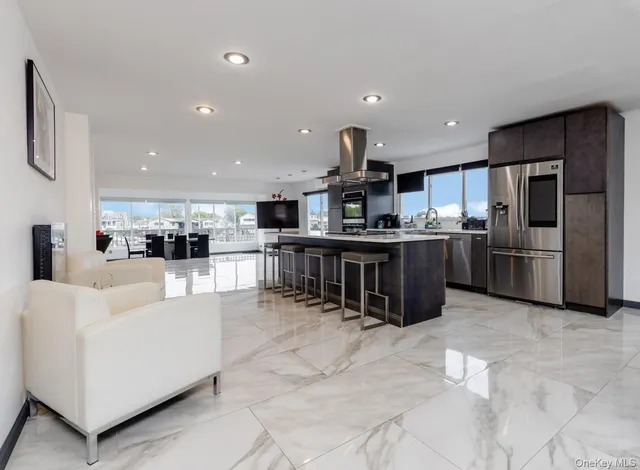 a large kitchen with stainless steel appliances lots of counter space and windows