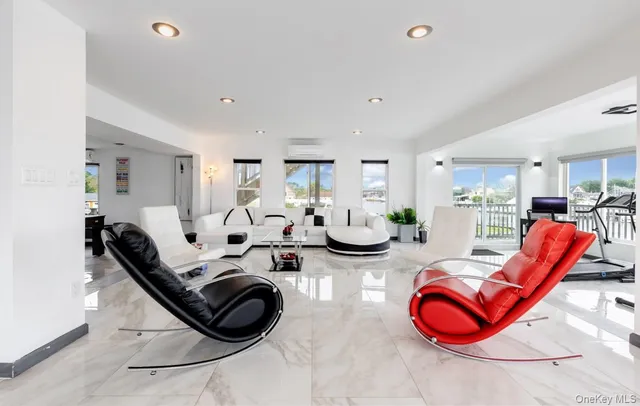 a living room with furniture a rug and white walls