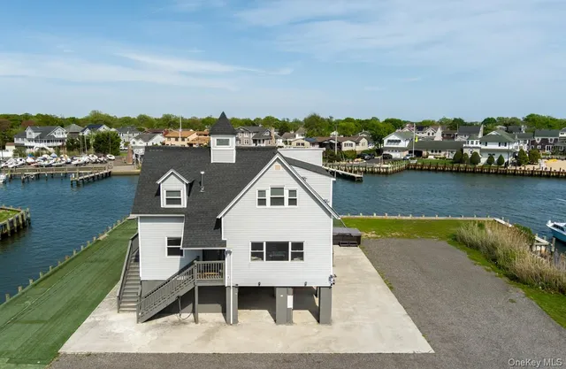 an aerial view of a house with a lake view