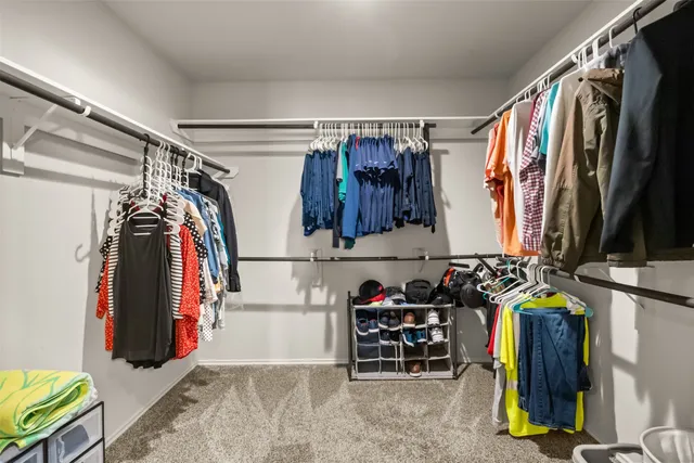 a view of a patio with a table and chairs under an umbrella