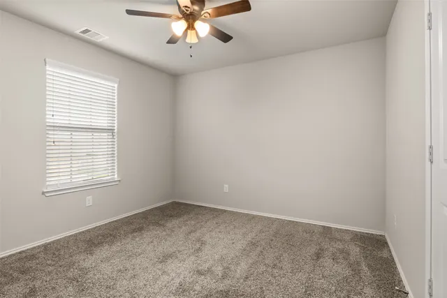 a living room with furniture and windows