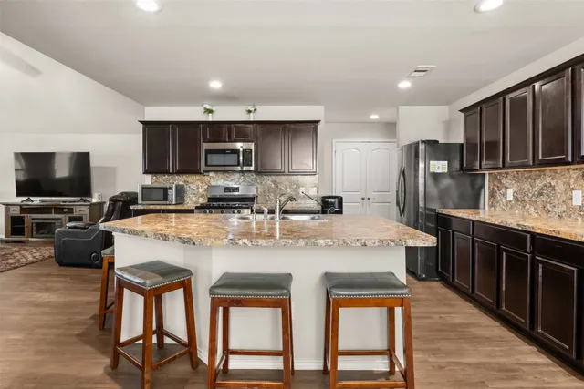 a kitchen with a stove a sink and a refrigerator