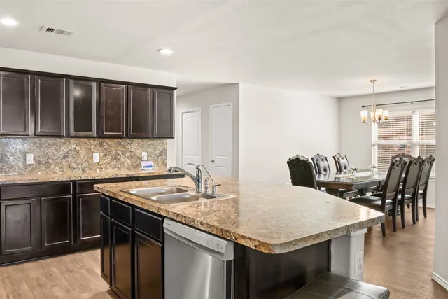 a dining room with furniture and wooden floor