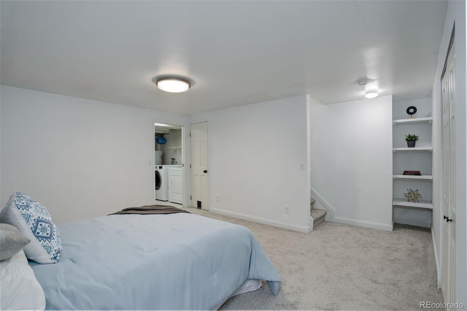 12132 Bannock Circle, Unit E Westminster, CO 80234 - Photo 16 of 26 a bedroom with a bed and cabinets