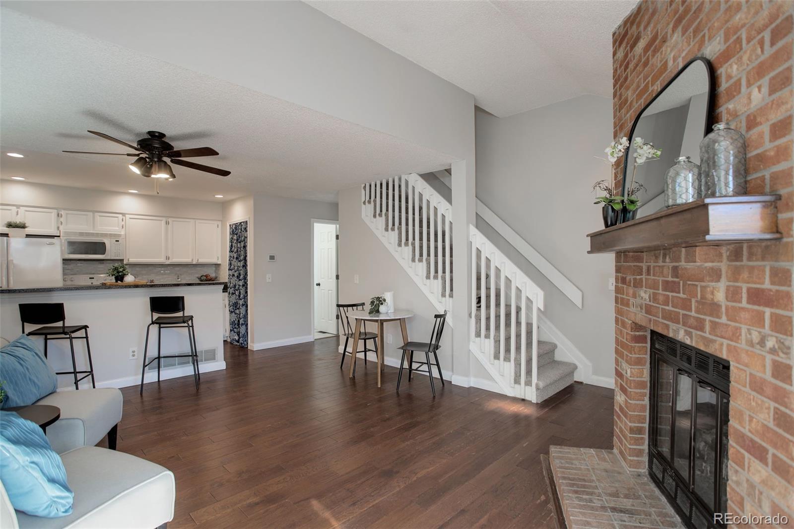 12132 Bannock Circle, Unit E Westminster, CO 80234 - Photo 3 of 26 a view of a livingroom with furniture and a fireplace