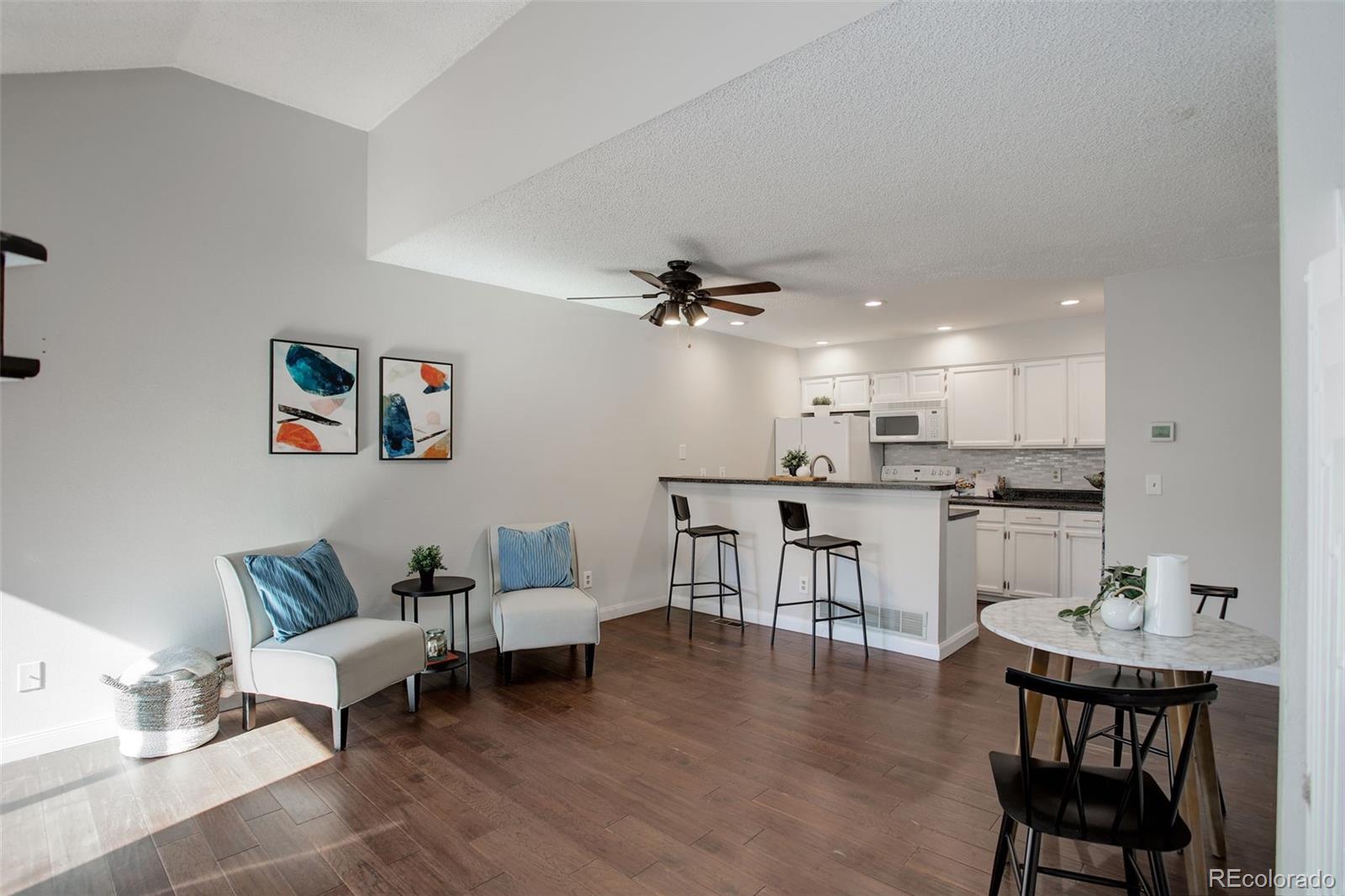 12132 Bannock Circle, Unit E Westminster, CO 80234 - Photo 5 of 26 a living room with furniture and kitchen view