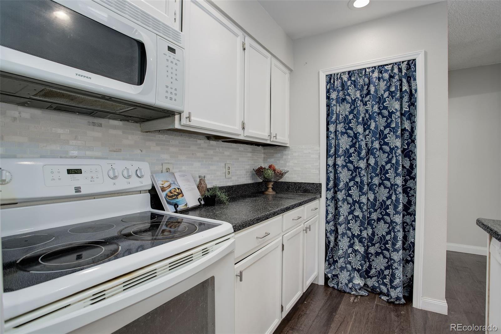 12132 Bannock Circle, Unit E Westminster, CO 80234 - Photo 7 of 26 a kitchen with granite countertop a sink and a stove