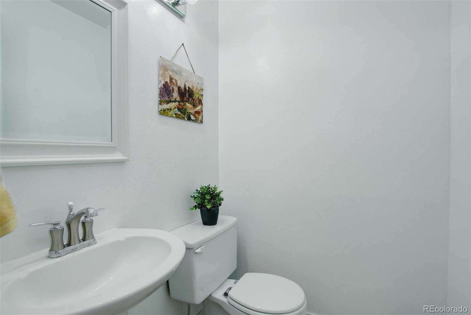 12132 Bannock Circle, Unit E Westminster, CO 80234 - Photo 10 of 26 a bathroom with a toilet sink and mirror