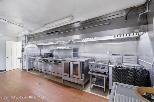 a kitchen with stainless steel appliances granite countertop a stove and a refrigerator