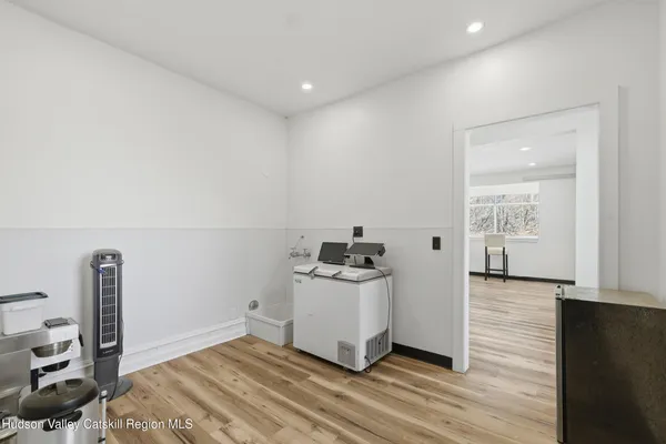 a kitchen with a stove and wooden floor