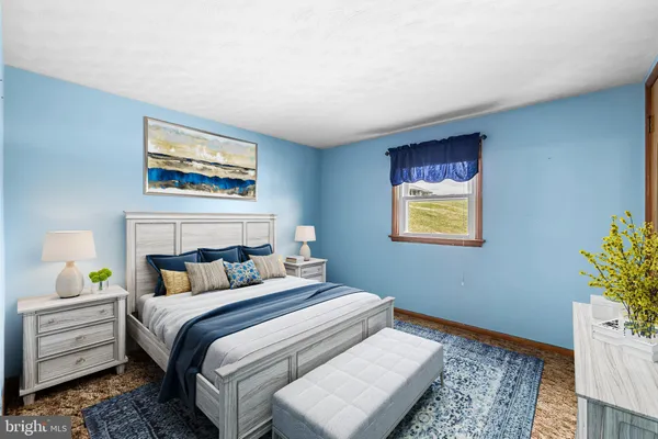a bedroom with a bed and dresser