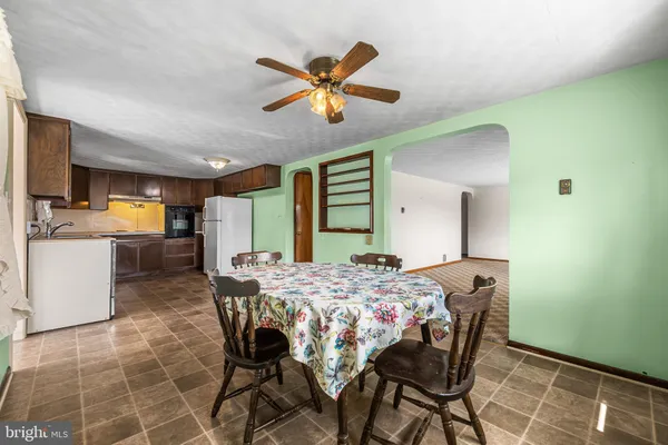 a large kitchen with a stove a refrigerator and a sink