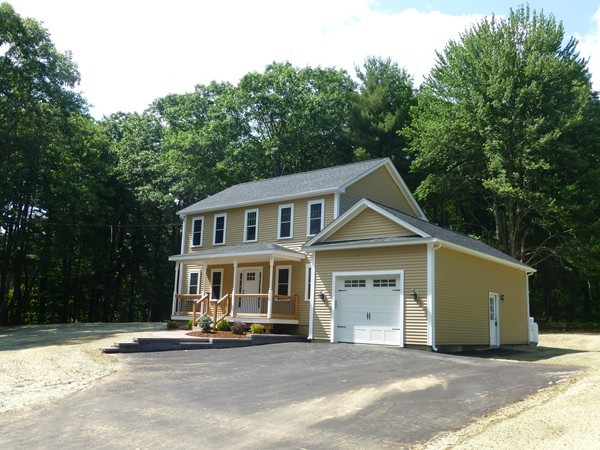 Lot 1 Baker Hill Road Spencer, MA 01562 - Photo 2 of 28 a front view of a house with a garden and trees