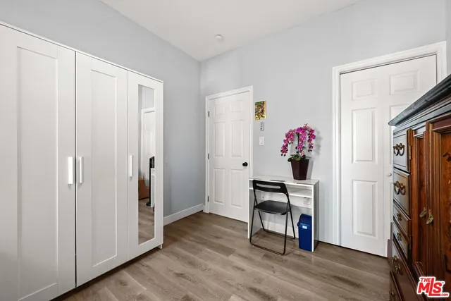 a view of a workspace with furniture and wooden floor