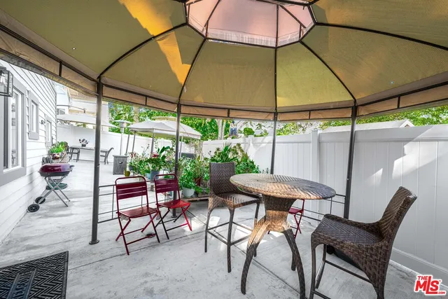 a patio with a yard table and chairs