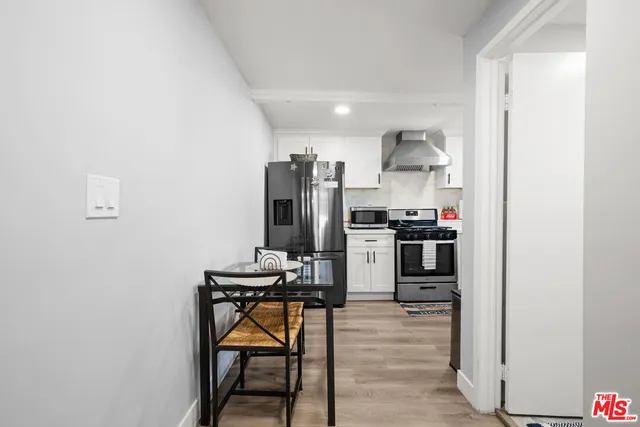a kitchen with stainless steel appliances kitchen island a refrigerator and a stove top oven