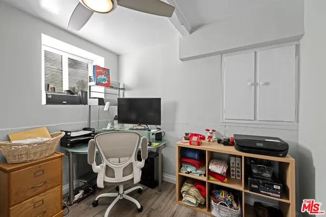 a view of a workspace with furniture and a window